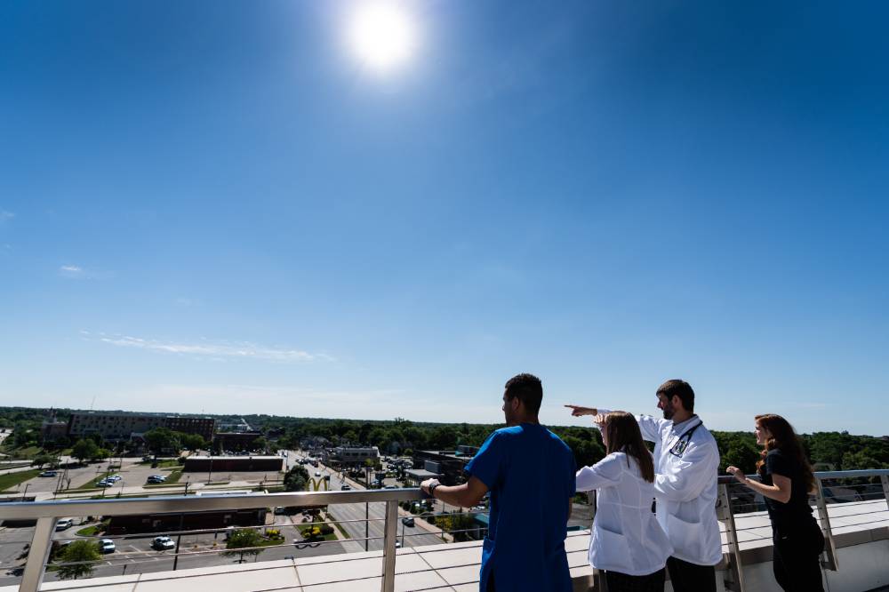 Students outside the Center for Interprofessional Health looking over the patio